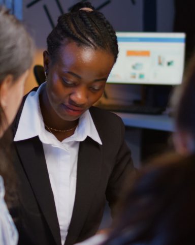 Black african american manager brainstorming company ideas checking management presentation paperwork working overtime in meeting room in evening. Diverse multi ethnic teamwork solving corporate ideas